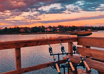 Chris Plaford - three fishing rods set up on a dock (two)